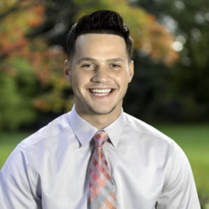 man smiling wearing shirt & tie