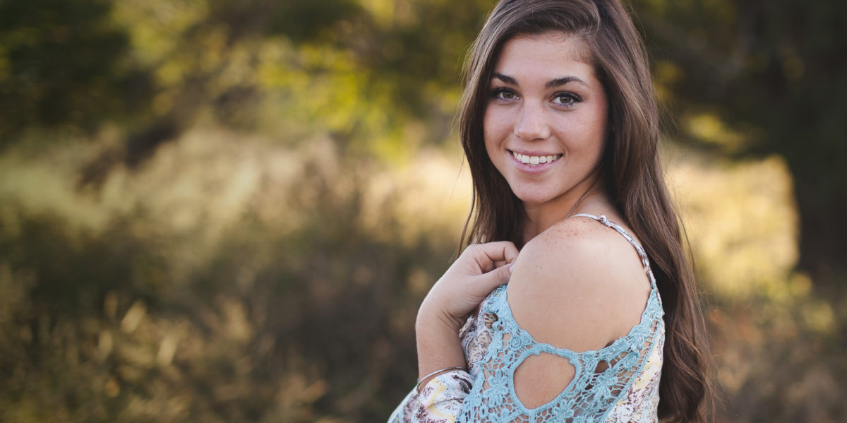 girl with brown hair smiling