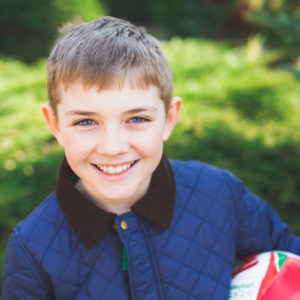 kid in blue jacket smiling