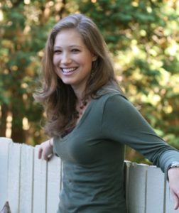 girl in green shirt smiling