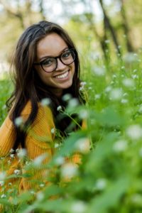 girl in yellow sweater smiling