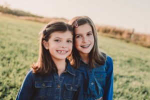 2 girls smiling in field