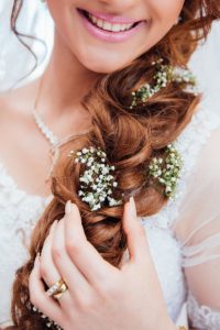 smile of girl with flowers in hair