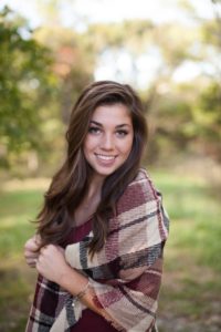 girl smiling by trees