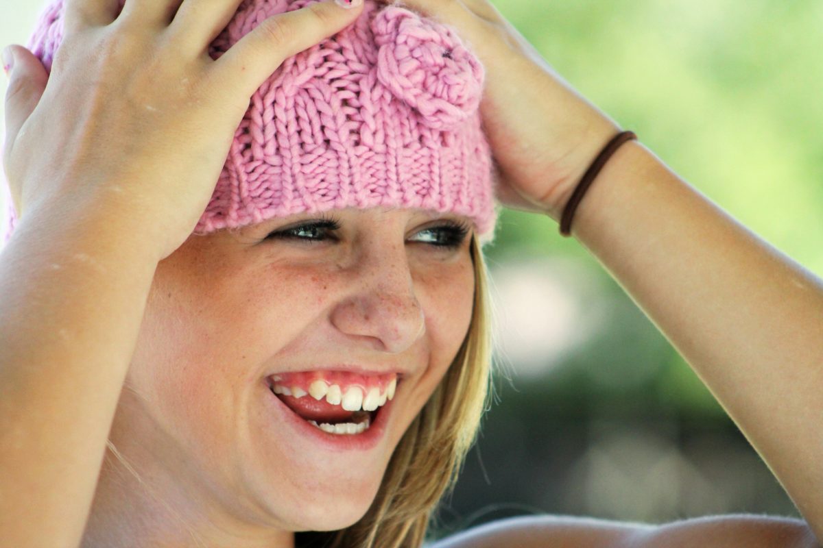girl-hat-happy-laughing-64230 Smiling Wisconsin Family on Bridge - All Patients at Moles & Ferri