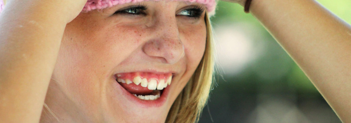 girl with pink hat smiling