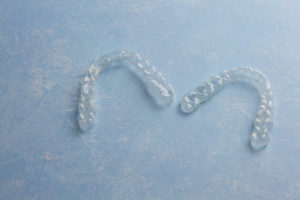 Clear Invisible Teeth Aligner on a blue background