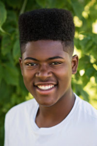 man outside smiling in white shirt