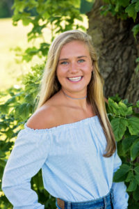 girl in blue shirt smiling