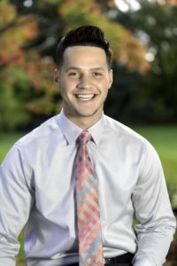 man with a tie smiling