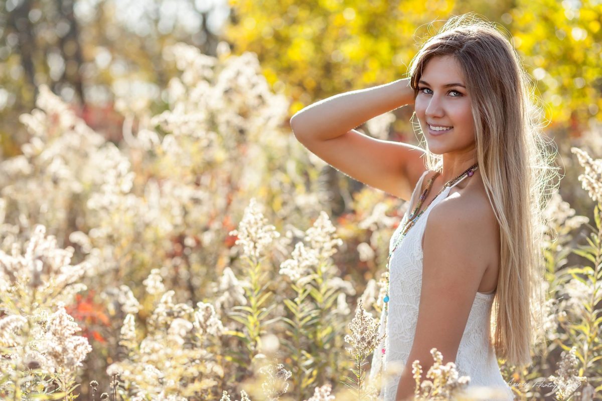 girl outdoors smiling in white